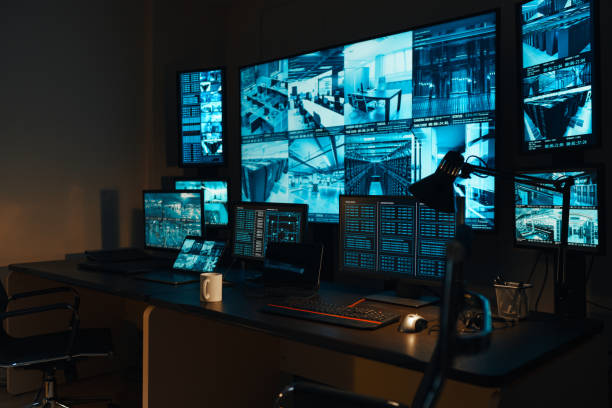 Security monitoring room with multiple surveillance screens showing camera feeds from Alaska business installation